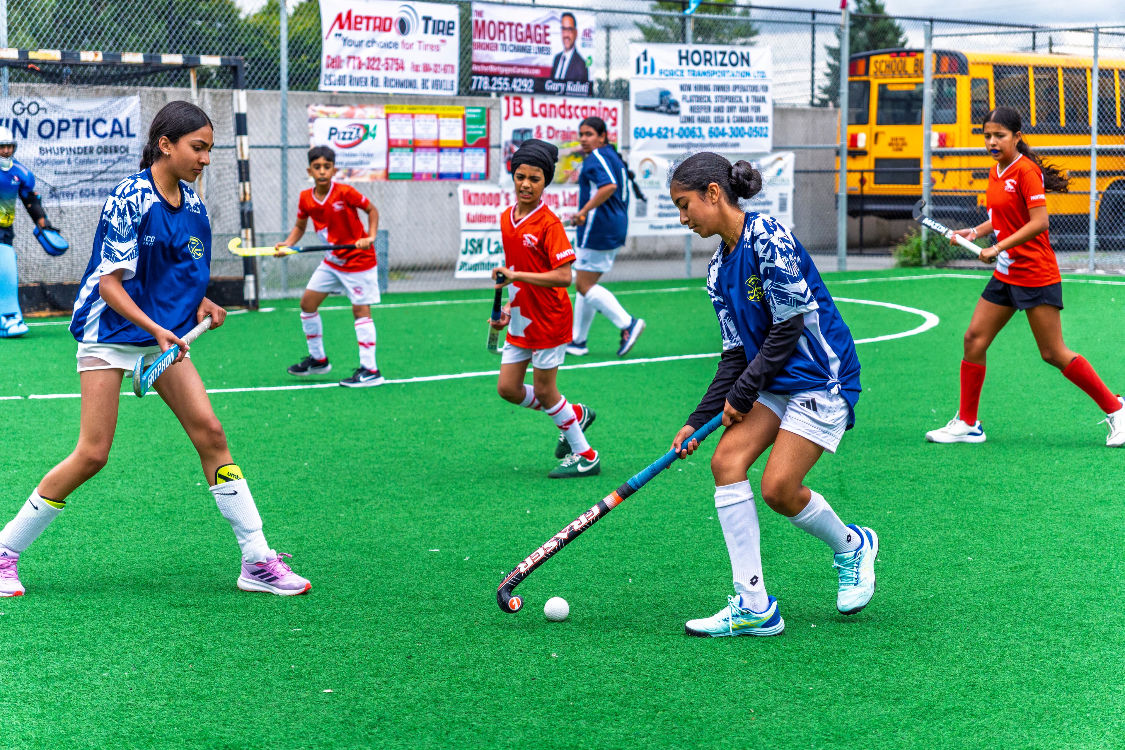 AFHC players competing for the ball during a field hockey match in Abbotsford, BC